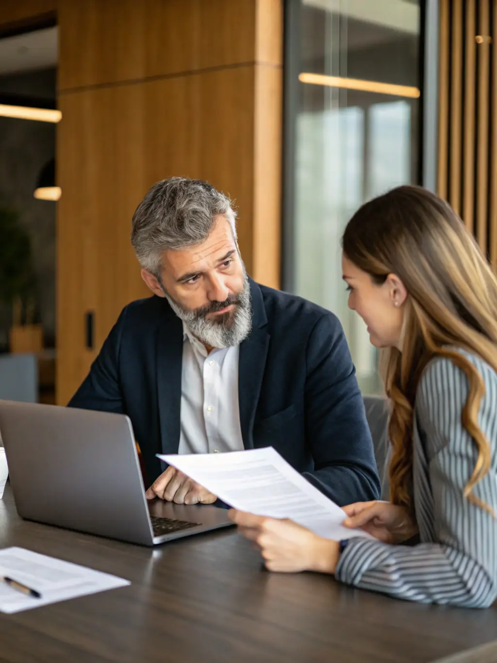 An image of a coach discussing strategies with a business owner in a modern office setting in London, symbolising guidance and collaboration in the UK business environment.